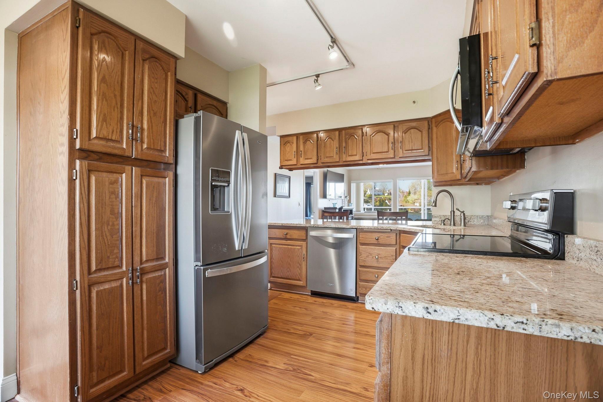 4 Marina Drive, Unit D2 Mahopac, NY 10541 - Photo 10 of 39 The kitchen features hardwood floors, stainless steel appliances, granite countertops, and wood cabinetry