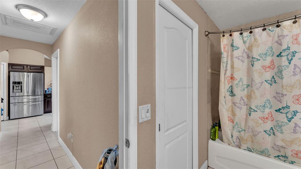 39360 Sparkman Road Dade City, FL 33525 - Photo 21 of 40 a bathroom with a shower and a tub