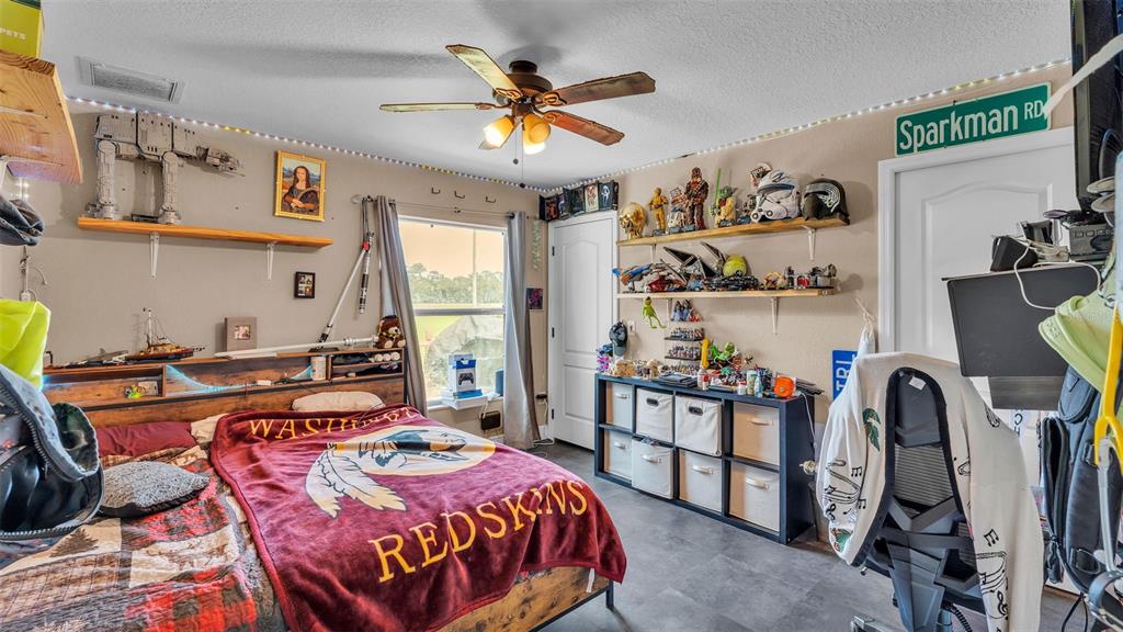 39360 Sparkman Road Dade City, FL 33525 - Photo 22 of 40 a bedroom with bed and wooden floor