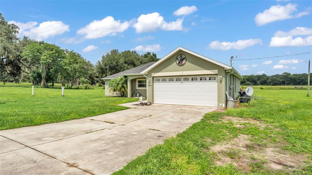 39360 Sparkman Road Dade City, FL 33525 - Photo 4 of 40 a front view of a house with a yard and garage