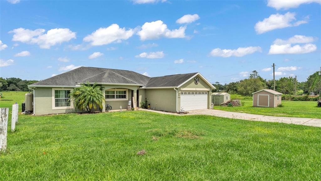 39360 Sparkman Road Dade City, FL 33525 - Photo 5 of 40 a view of a house with a big yard and large trees