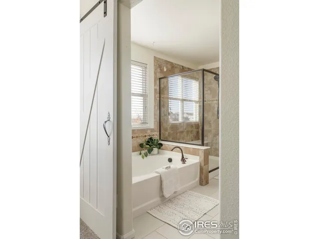 a en suite bathroom with a double vanity sink and a mirror