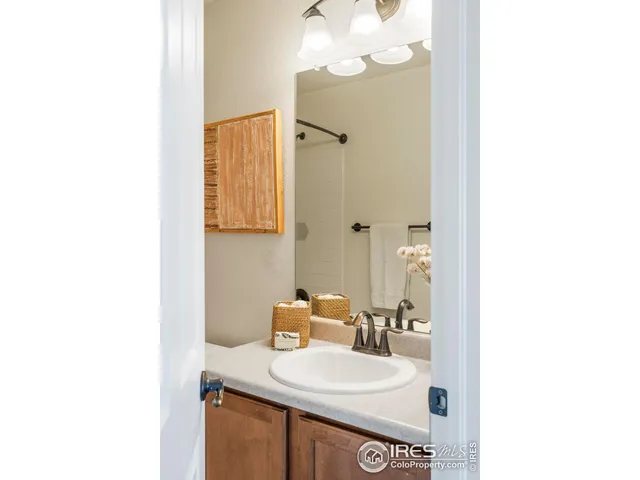 a bathroom with a sink mirror and a