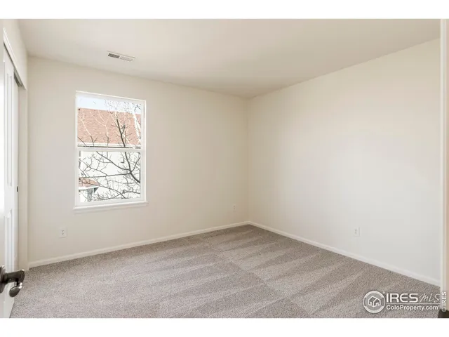 a view of a room with a table and chairs