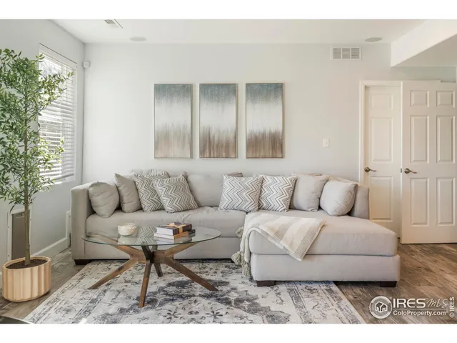 a living room with stainless steel appliances kitchen island granite countertop furniture and a potted plant