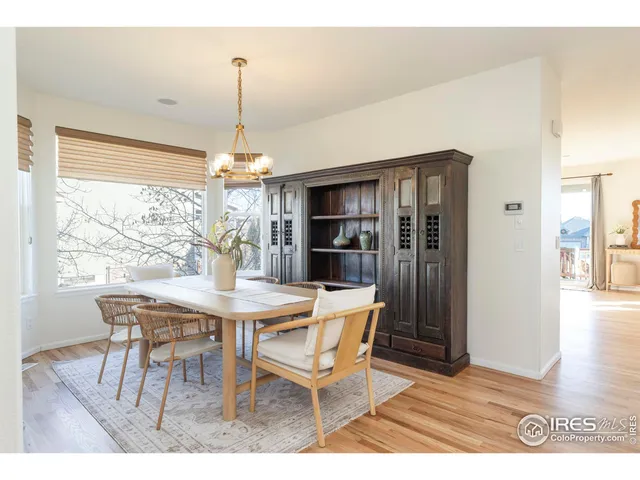a dining room with furniture and wooden floor