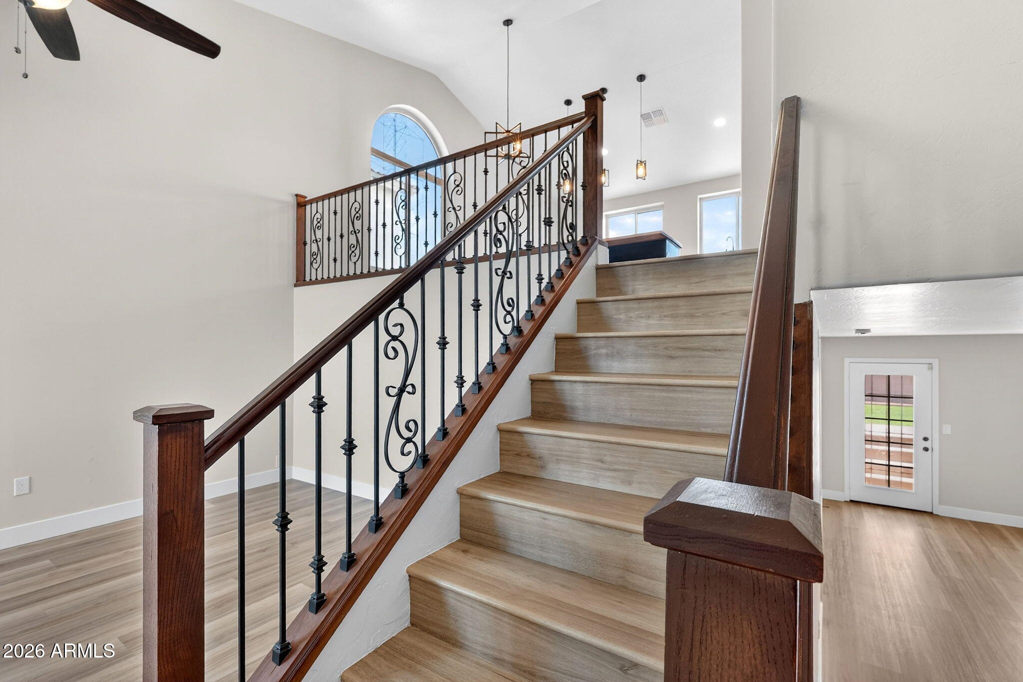 1417 East Mineral Road Gilbert, AZ 85234 - Photo 14 of 59 a view of staircase with lots of frames on wall and a window