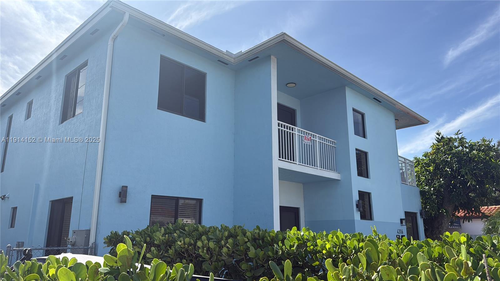 a view of a house with brick walls and plants