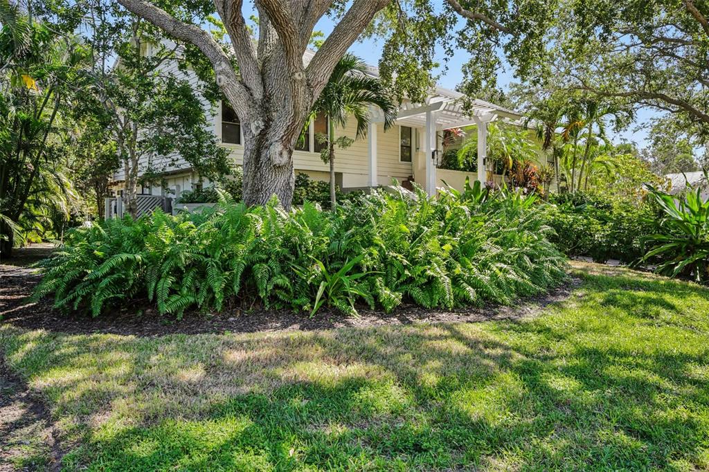 3390 Bayou Sound Longboat Key, FL 34228 - Photo 45 of 59 a front view of a house with garden