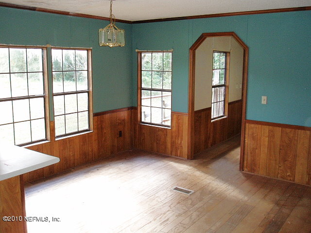 45193 Bismark Road Callahan, FL 32011 - Photo 3 of 11 a view of an empty room with window and wooden floor