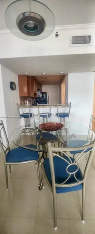 a kitchen with a sink a stove and chairs