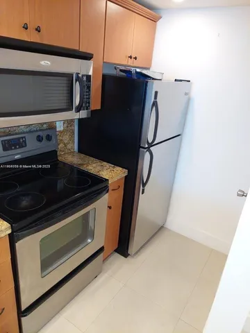 a stove top oven sitting inside of a kitchen