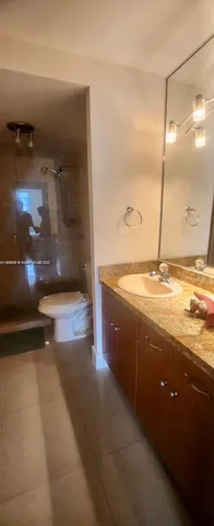 a view of a bathroom with a sink and mirror