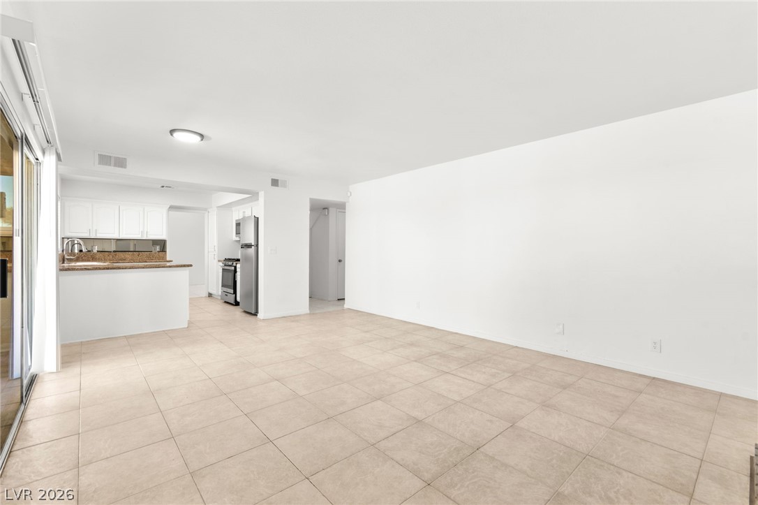 4430 Cranbrook Way Las Vegas, NV 89103 - Photo 13 of 50 An open-concept living area seamlessly connects to a streamlined kitchen, offering an inviting and functional space.