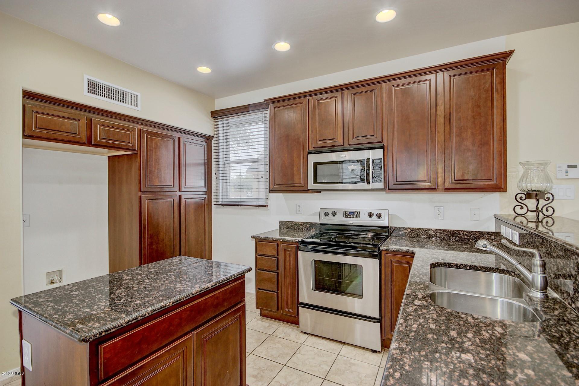 2328 East Fraktur Road Phoenix, AZ 85040 - Photo 10 of 26 a kitchen with granite countertop cabinets stainless steel appliances and a counter space