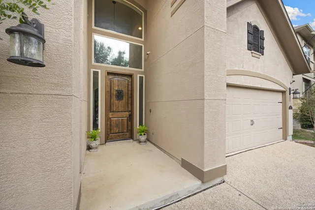 a open kitchen with stainless steel appliances kitchen island a white cabinets and couches