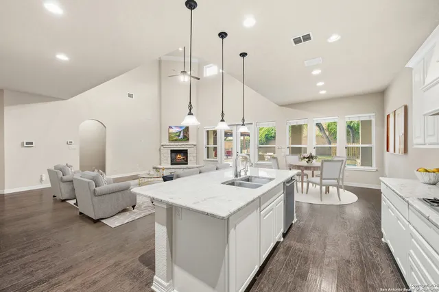 a bathroom with a sink vanity mirror and toilet