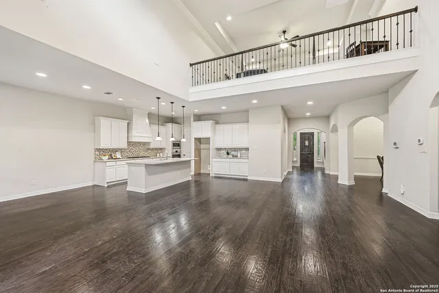 a living room with furniture and a ceiling fan