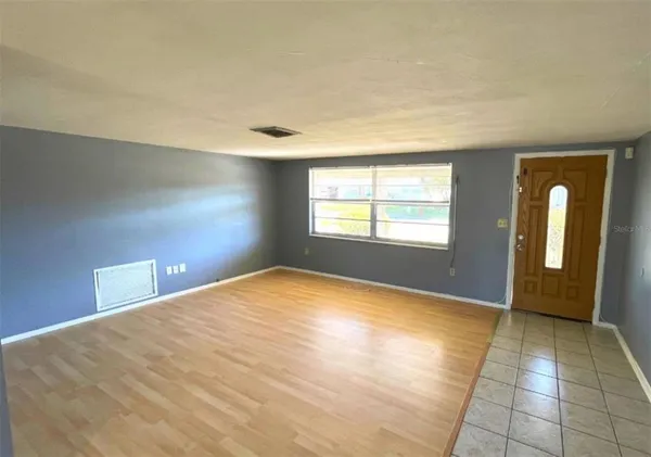 a view of an empty room with glass door