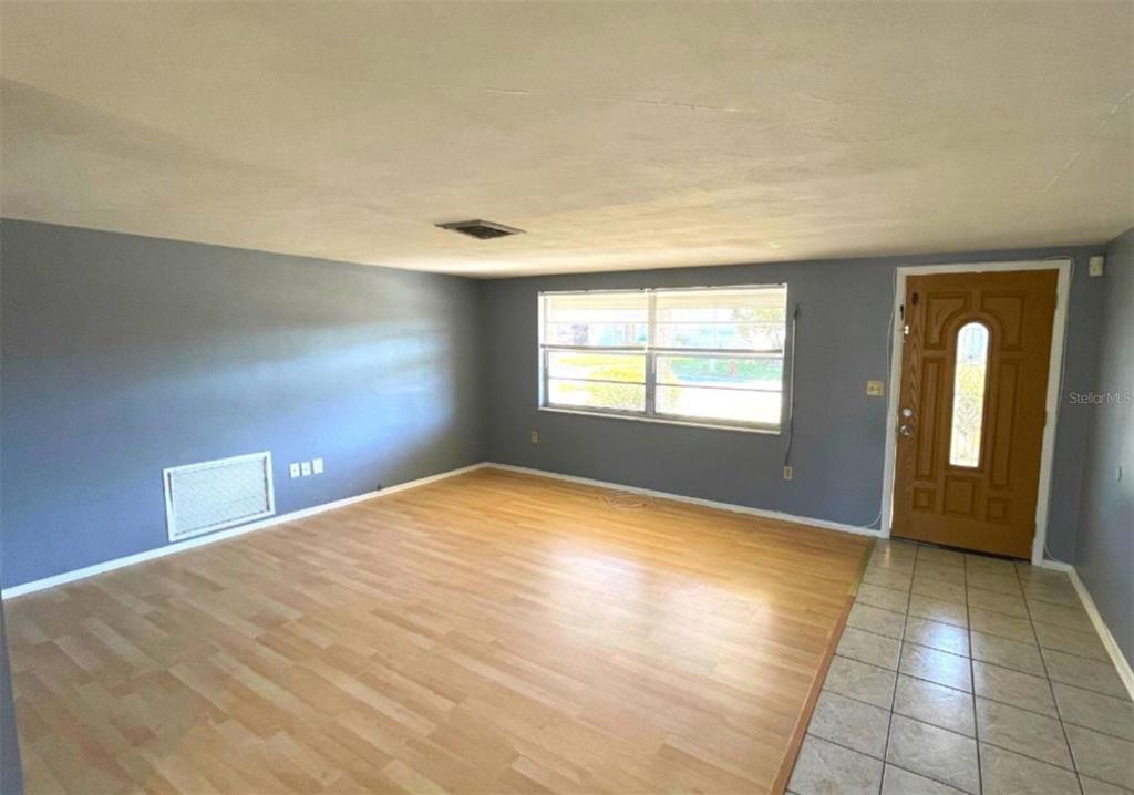 7335 Ashwood Drive Port Richey, FL 34668 - Photo 2 of 12 a view of an empty room with glass door