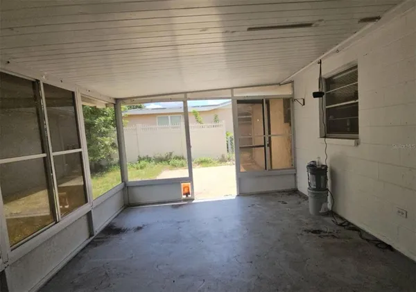 a view of an empty room with glass door