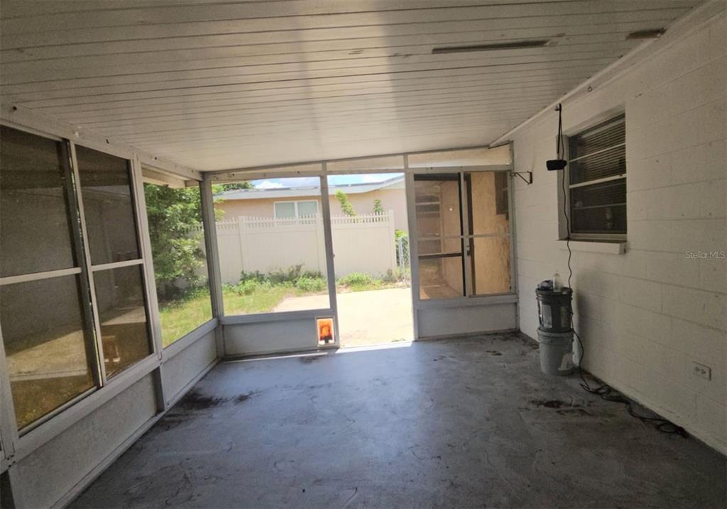 7335 Ashwood Drive Port Richey, FL 34668 - Photo 8 of 12 a view of an empty room with glass door