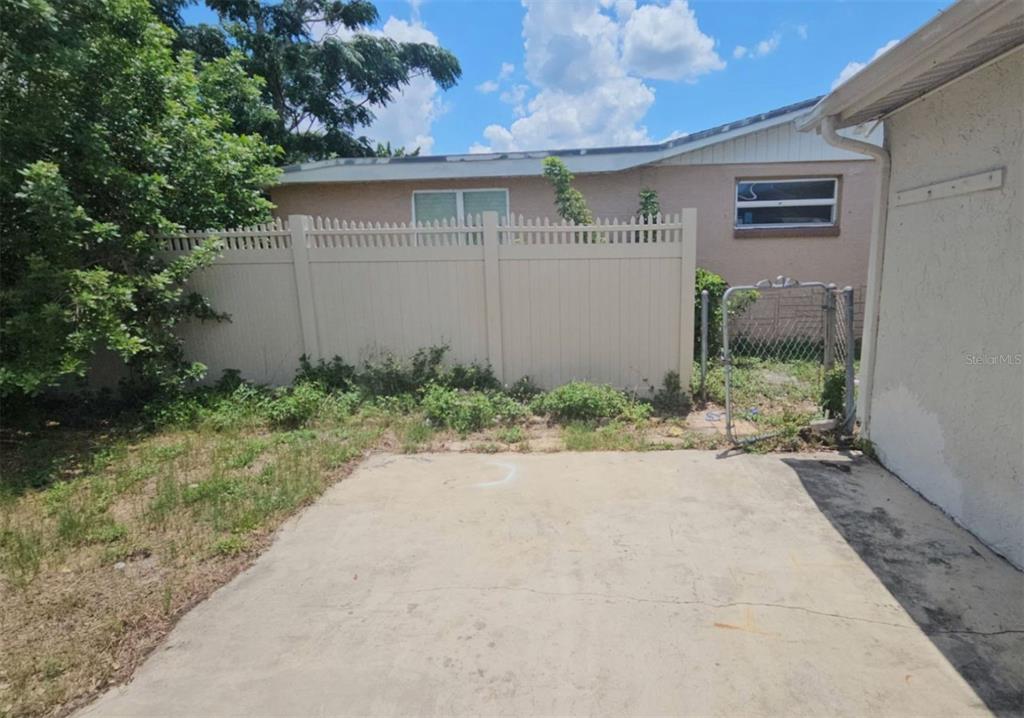 7335 Ashwood Drive Port Richey, FL 34668 - Photo 9 of 12 a front view of a house with garden