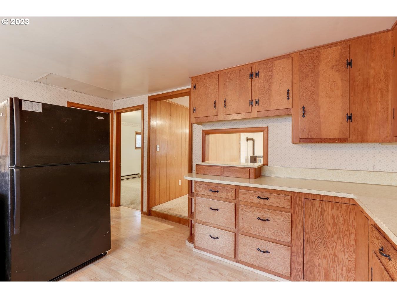 39161 Southeast Rude Road, Unit B Sandy, OR 97055 - Photo 13 of 32 a kitchen with a refrigerator and cabinets