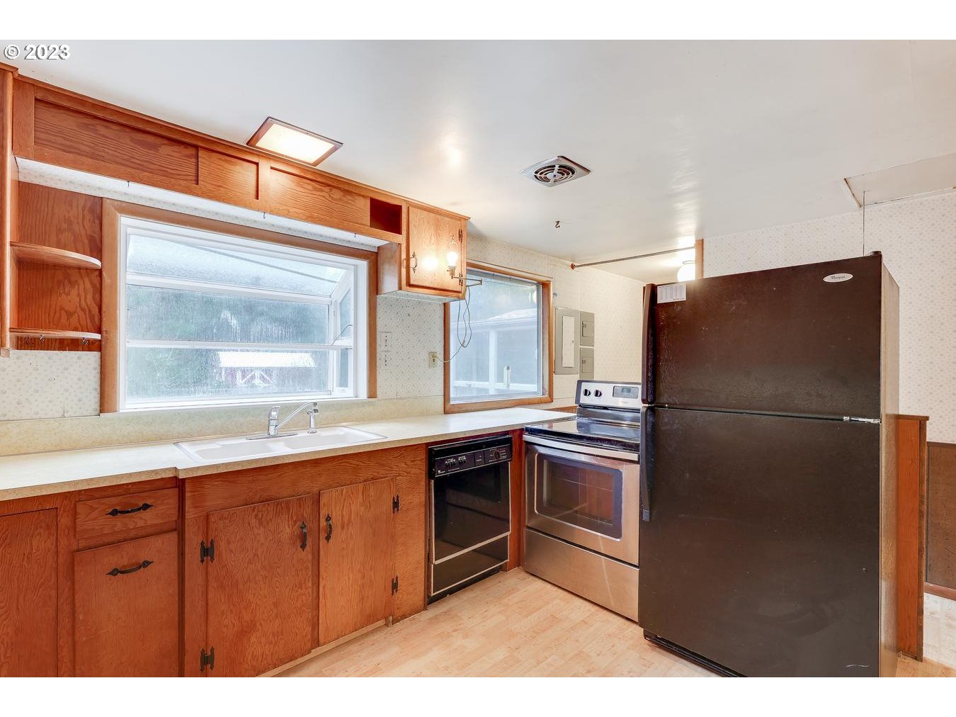 39161 Southeast Rude Road, Unit B Sandy, OR 97055 - Photo 16 of 32 a kitchen with stainless steel appliances granite countertop a refrigerator a sink a stove and white cabinets