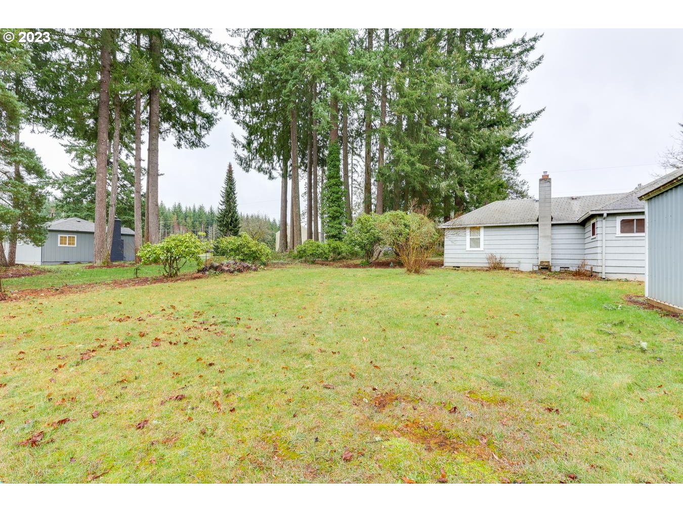 39161 Southeast Rude Road, Unit B Sandy, OR 97055 - Photo 31 of 32 a view of a house with a yard and large trees
