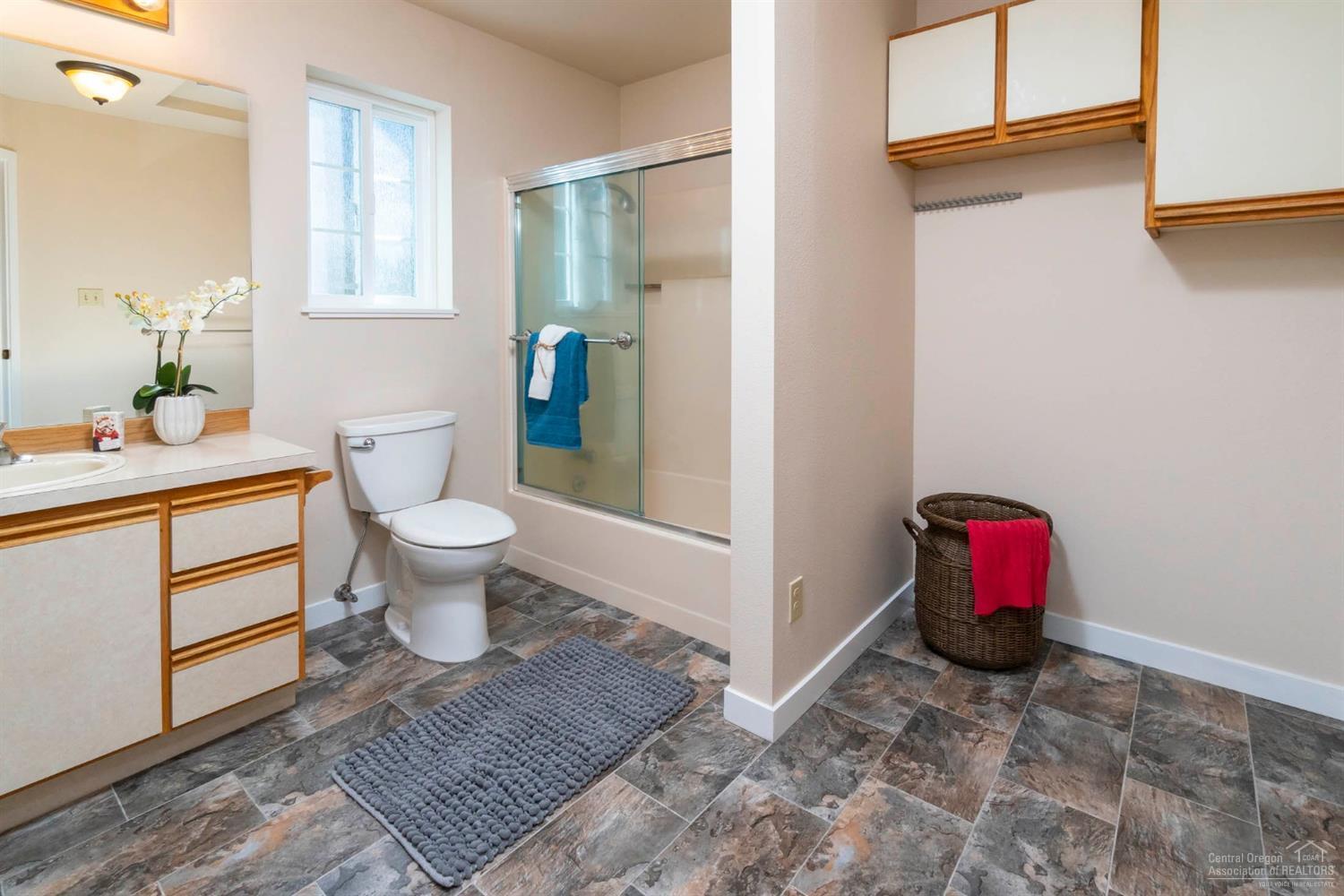 60098 Cinder Butte Road Bend, OR 97702 - Photo 16 of 25 a bathroom with a sink toilet and vanity