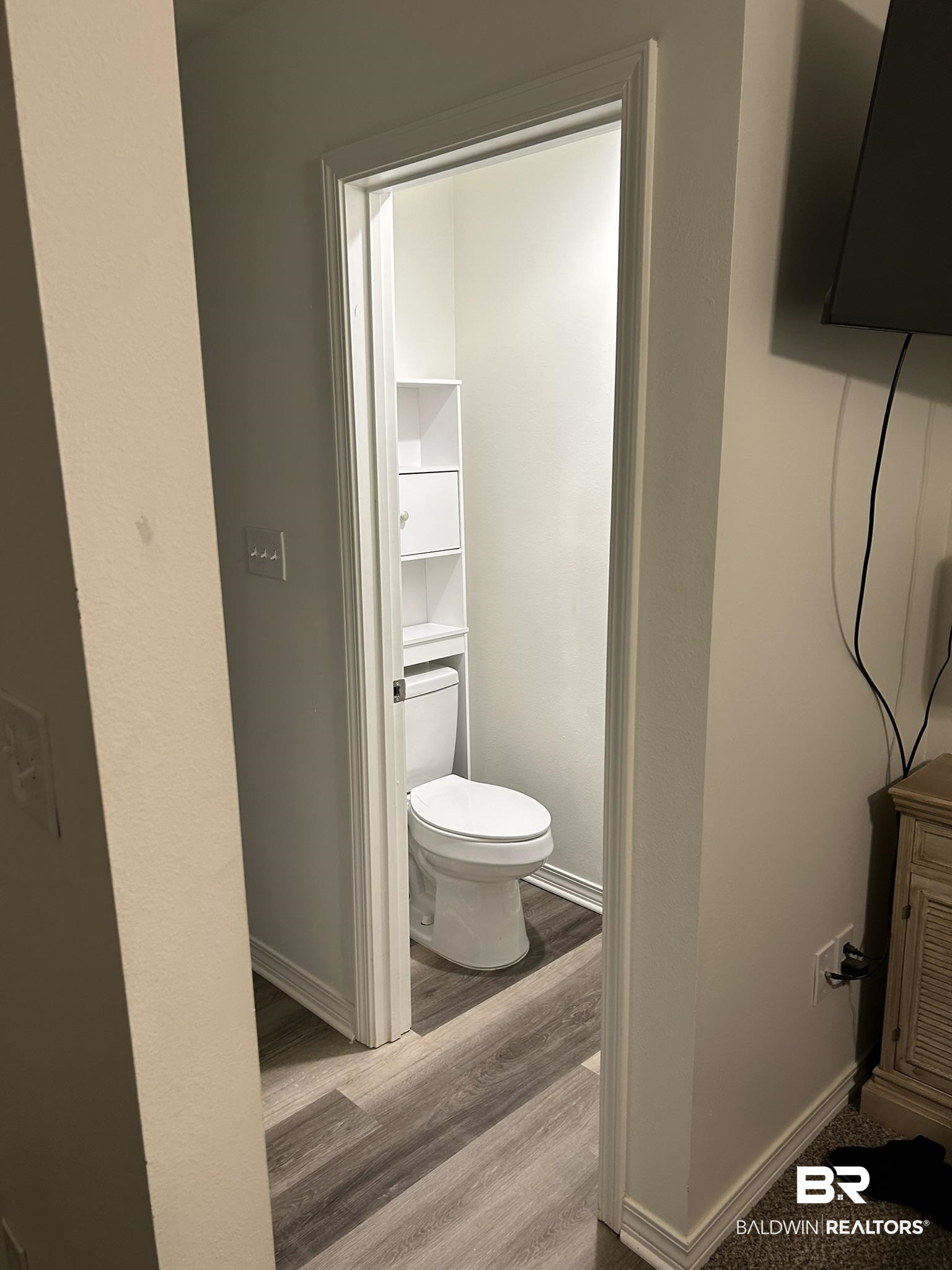 2 Canterberry Circle Foley, AL 36535 - Photo 10 of 24 Bathroom featuring toilet, baseboards, and wood finished floors