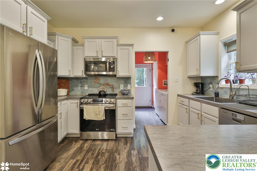 318 Church Road Kunkletown, PA 18058 - Photo 19 of 51 A contemporary kitchen showcasing wood-look flooring and light-toned cabinetry.