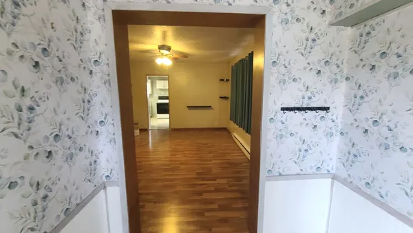 a view of gallery with wooden floor