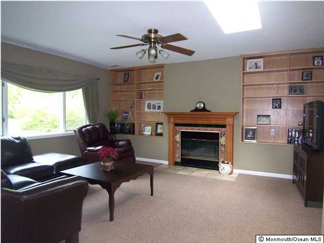 32 Rivers Edge Drive Little Silver, NJ 07739 - Photo 2 of 3 a living room with furniture a fireplace and a window