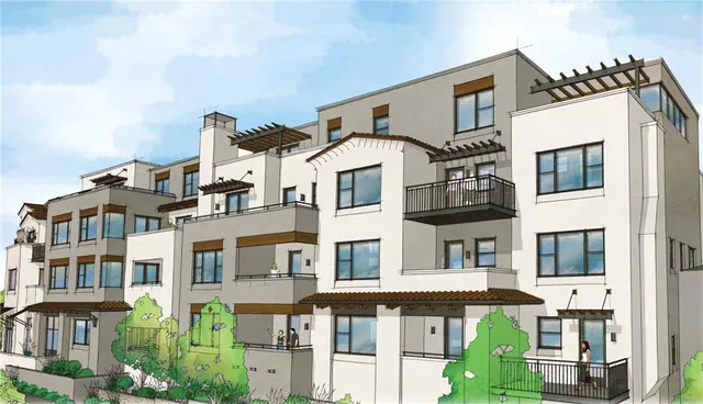 a front view of a residential apartment building with a yard