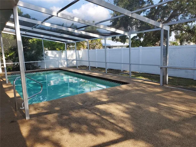 a view of a backyard with swimming pool