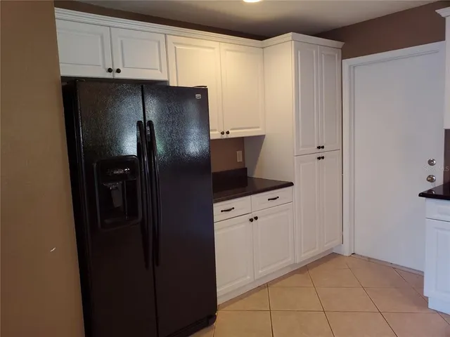 a kitchen with stainless steel appliances a refrigerator and cabinets