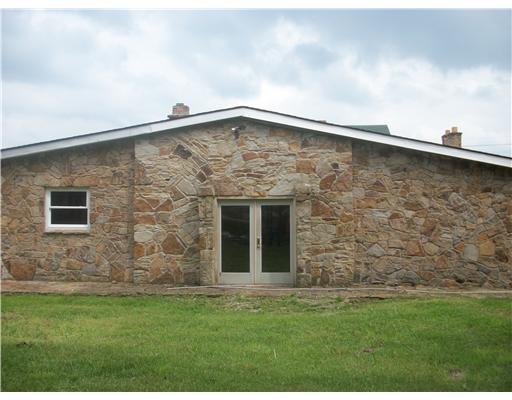 325 Freeman Falls Road Acme, PA 15610 - Photo 2 of 18 Exterior Back. Beautiful stonework-patio overlooks acreage and fruit trees.