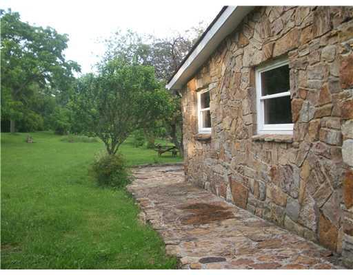 325 Freeman Falls Road Acme, PA 15610 - Photo 17 of 18 Patio/Deck. Stone patio off rear of home.
