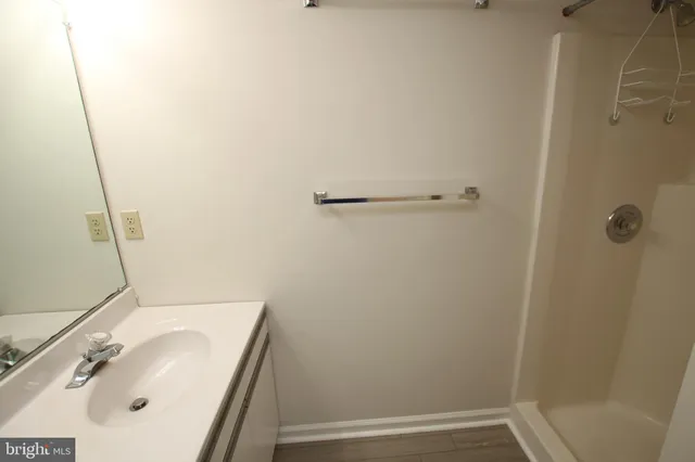 a white toilet sitting next to a small window