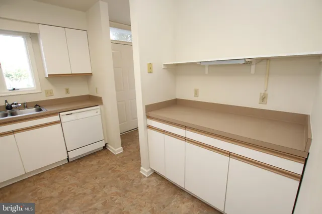 a utility room with cabinets washer and dryer