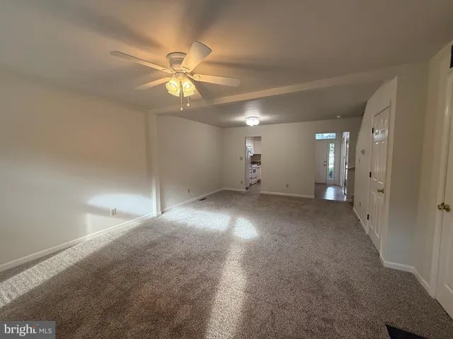 a view of an empty room with a fireplace