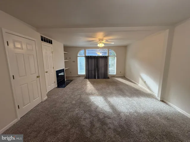 a view of a hallway with wooden shelves
