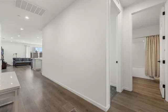 a kitchen with stainless steel appliances granite countertop a sink a stove and a refrigerator