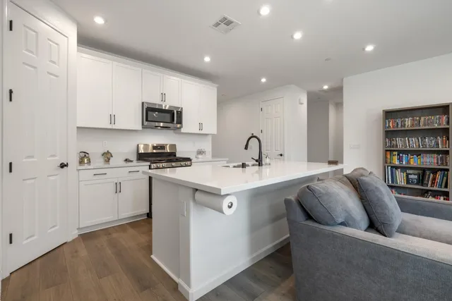 a view of a a dining room with furniture window and wooden floor