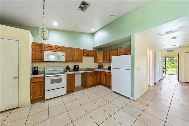 a kitchen with a refrigerator and a stove top oven