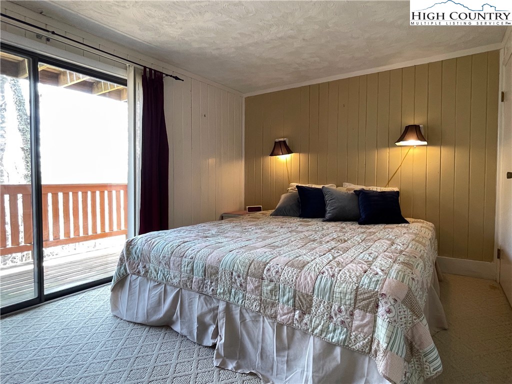 102 Skiview Lane, Unit A3 Beech Mountain, NC 28604 - Photo 11 of 20 a bedroom with a bed and wooden floor