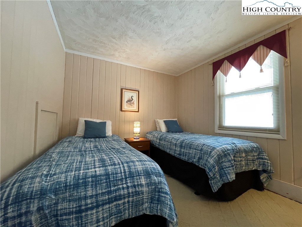 102 Skiview Lane, Unit A3 Beech Mountain, NC 28604 - Photo 14 of 20 a bedroom with two beds and a window