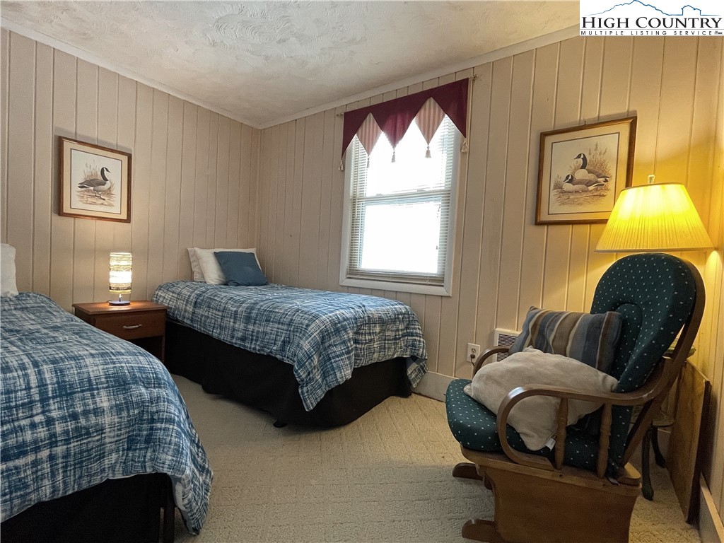 102 Skiview Lane, Unit A3 Beech Mountain, NC 28604 - Photo 15 of 20 a bedroom with two beds and a window